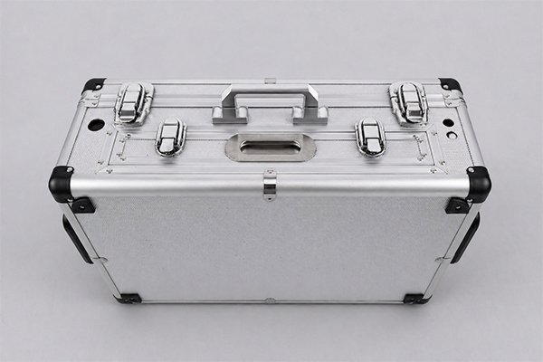 Lockable Aluminum Storage Case with Reinforced Corners Top view of a silver aluminum case with carrying handles, latches, and reinforced corner caps